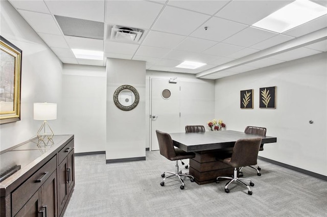 carpeted office with a paneled ceiling