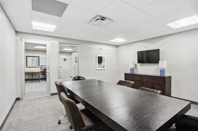 office area featuring light carpet and a drop ceiling