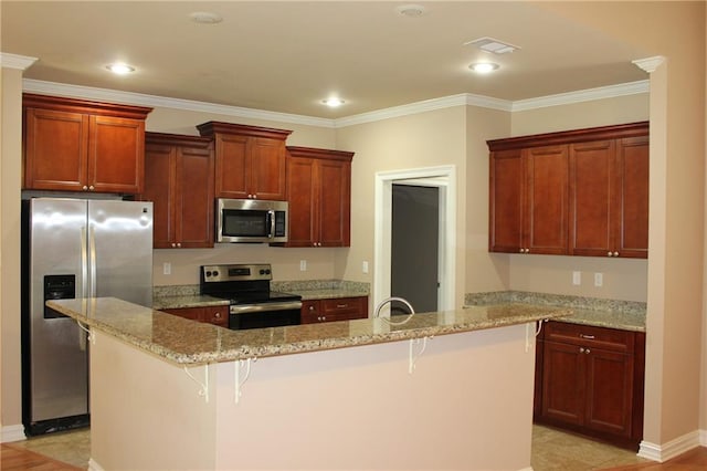 kitchen with light stone countertops, stainless steel appliances, ornamental molding, and a kitchen breakfast bar