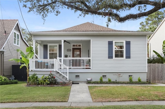 view of front facade with a yard and ceiling fan