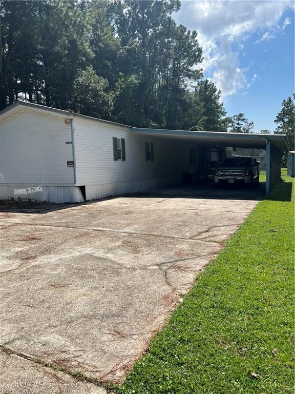 view of property exterior with a lawn and a carport