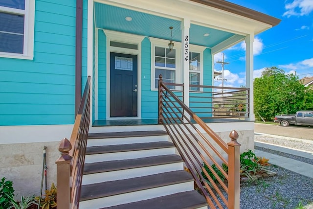 view of exterior entry featuring a porch