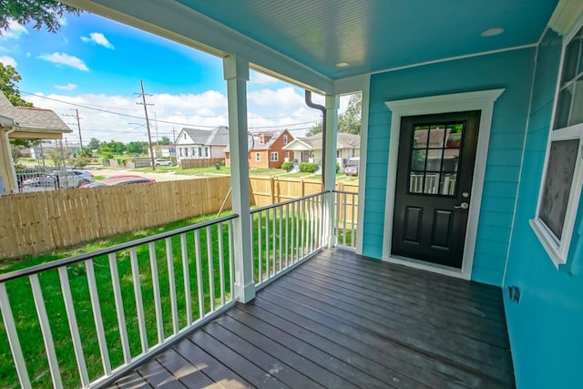 wooden deck with a porch and a yard