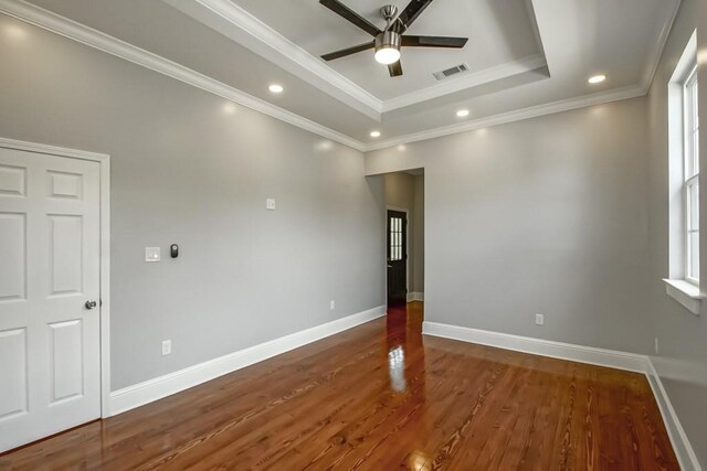 unfurnished room with crown molding, dark hardwood / wood-style floors, ceiling fan, and plenty of natural light