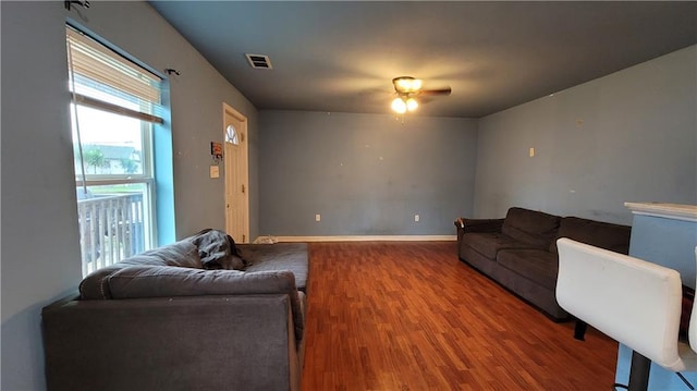 living room with wood-type flooring and ceiling fan