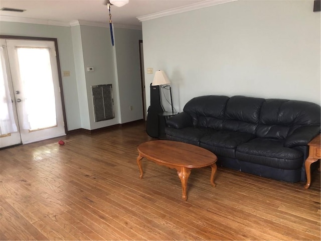 living room featuring wood-type flooring, french doors, and ornamental molding