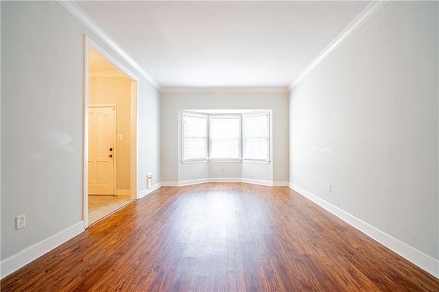 unfurnished room featuring crown molding and wood-type flooring