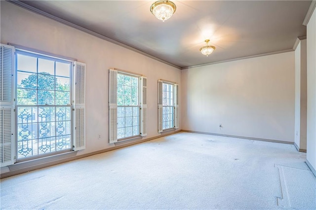 empty room featuring carpet, a notable chandelier, and crown molding