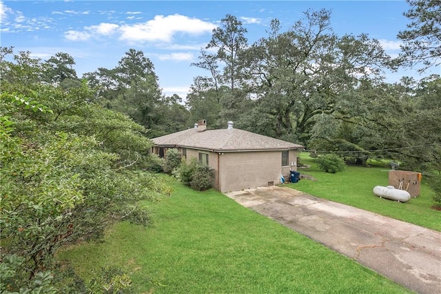 view of side of home featuring a lawn