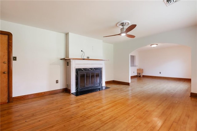 unfurnished living room featuring wood-type flooring and ceiling fan