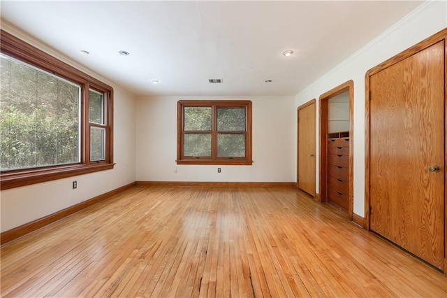 spare room featuring light hardwood / wood-style flooring and a wealth of natural light