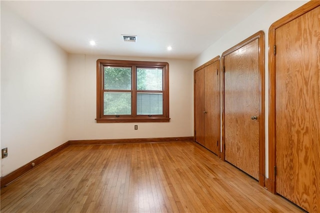 unfurnished bedroom with light wood-type flooring