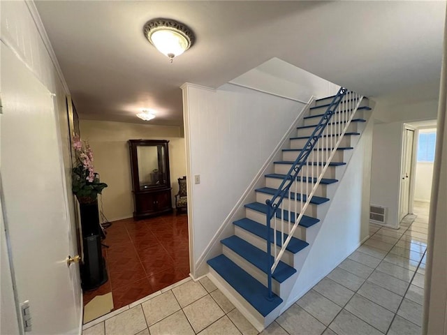 stairs with tile patterned floors