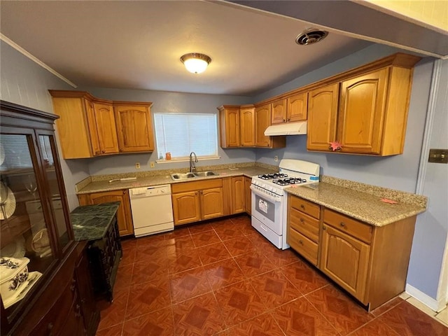 kitchen featuring white appliances, light stone countertops, crown molding, dark tile patterned floors, and sink