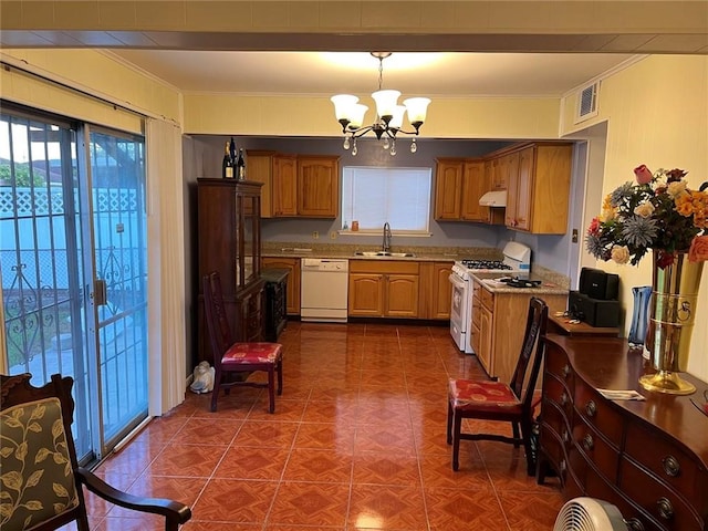 kitchen with sink, white appliances, decorative light fixtures, light stone countertops, and crown molding