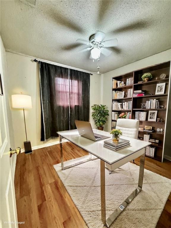 sitting room featuring a textured ceiling, hardwood / wood-style flooring, and ceiling fan