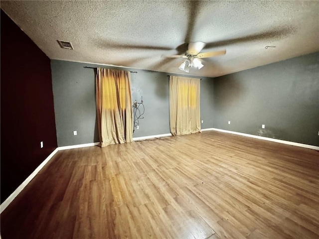 unfurnished bedroom featuring hardwood / wood-style floors, a textured ceiling, and ceiling fan