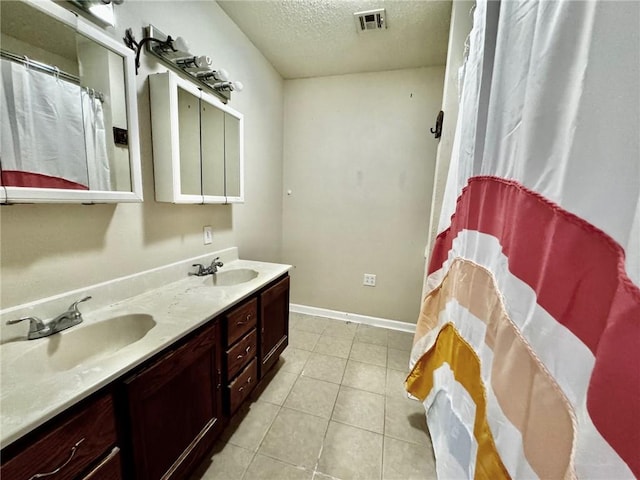 bathroom featuring vanity, a textured ceiling, and tile patterned floors