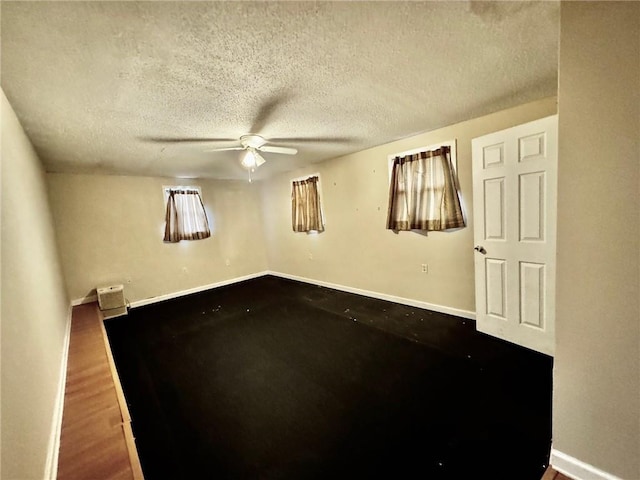 unfurnished room featuring ceiling fan, a textured ceiling, and wood-type flooring