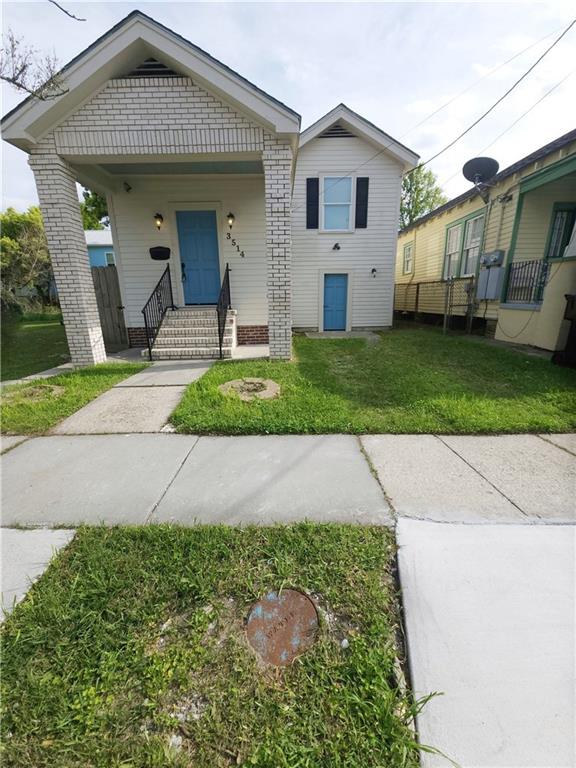 bungalow-style home with a front yard