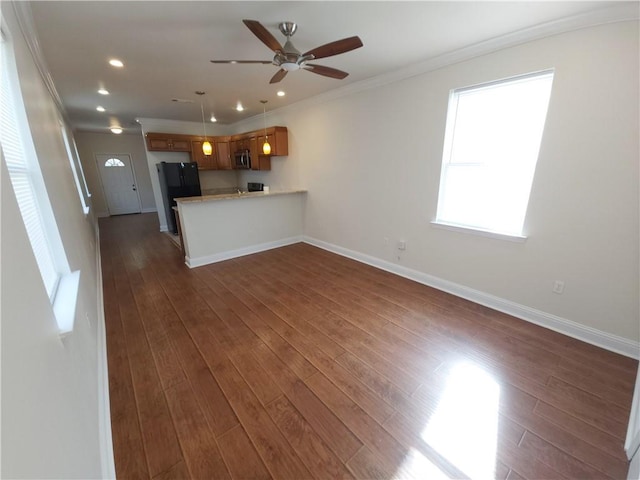 unfurnished living room with ornamental molding, ceiling fan, and dark hardwood / wood-style flooring