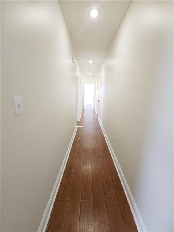 corridor with dark hardwood / wood-style floors