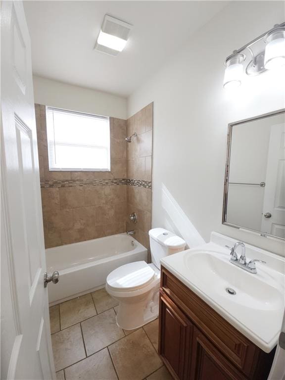 full bathroom with vanity, tile patterned flooring, toilet, and tiled shower / bath combo