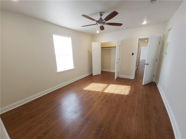 unfurnished bedroom featuring a closet, hardwood / wood-style flooring, and ceiling fan