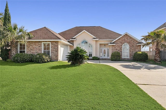 single story home with a front yard and a garage