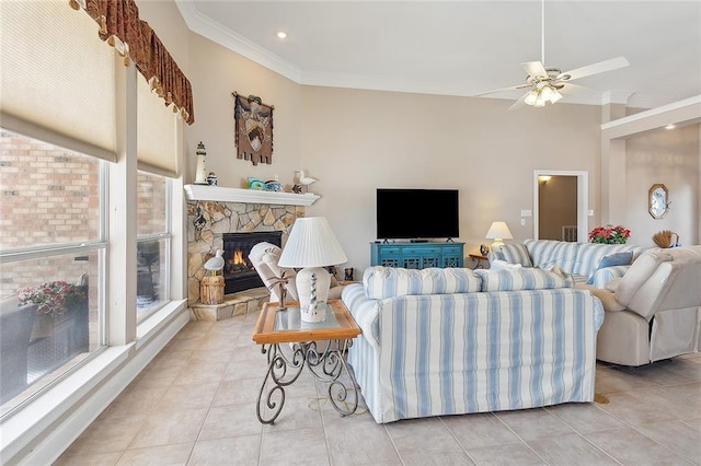 tiled living room with ceiling fan, crown molding, and a fireplace