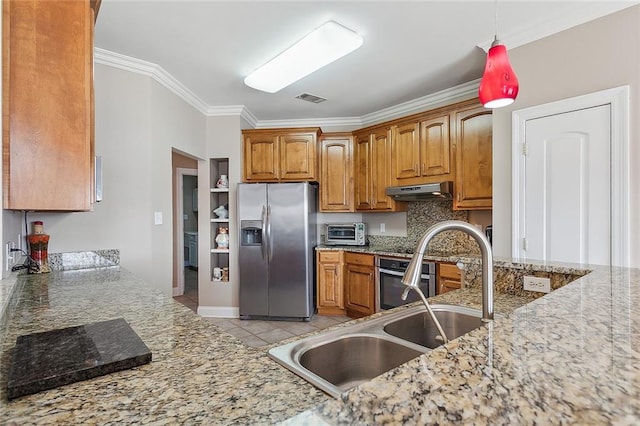 kitchen with light stone counters, stainless steel appliances, and tasteful backsplash