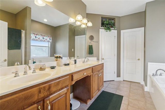 bathroom featuring a washtub, vanity, and tile patterned floors