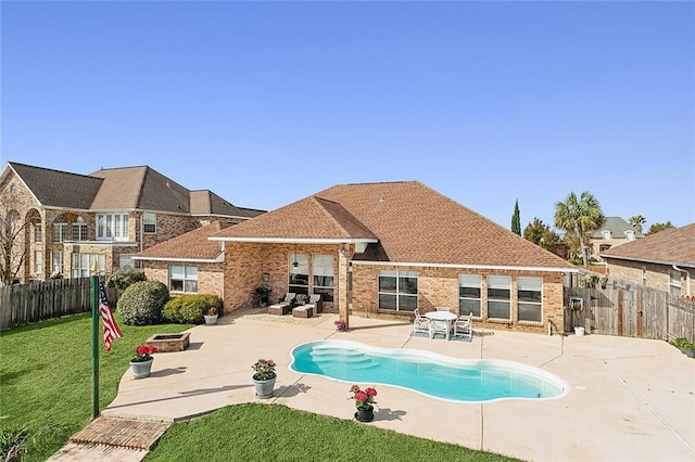 view of swimming pool featuring a patio area and a lawn