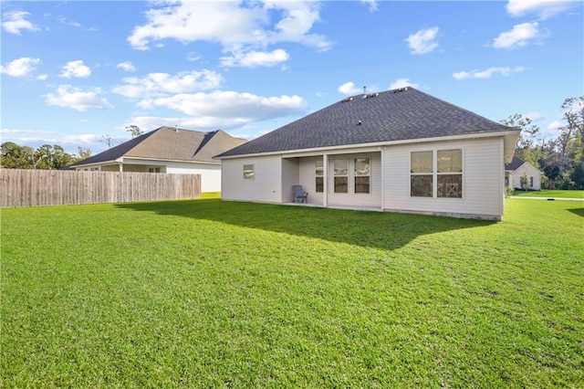 back of property featuring a lawn