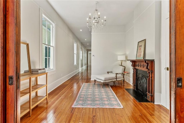 living area with an inviting chandelier and hardwood / wood-style flooring