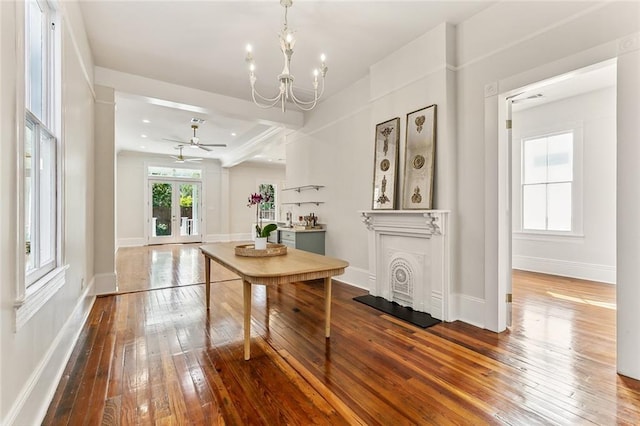 dining space featuring ceiling fan with notable chandelier, hardwood / wood-style floors, and french doors