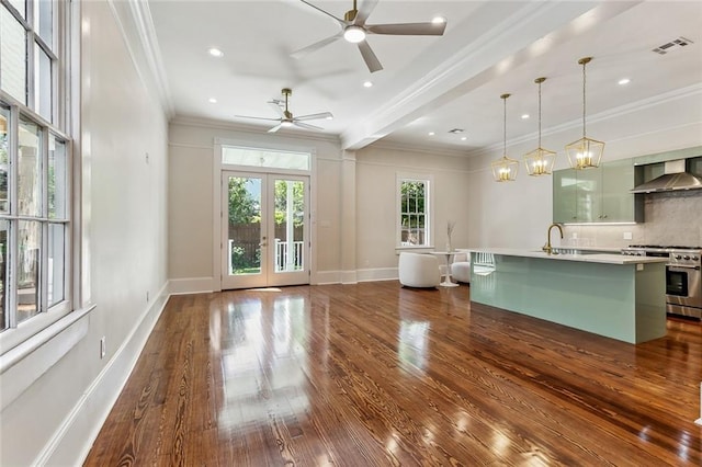 interior space with sink, french doors, dark hardwood / wood-style floors, ceiling fan with notable chandelier, and crown molding