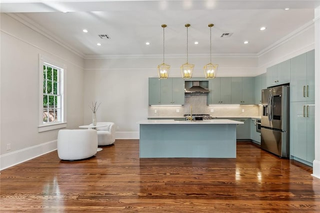 kitchen featuring appliances with stainless steel finishes, dark hardwood / wood-style floors, wall chimney exhaust hood, and decorative backsplash