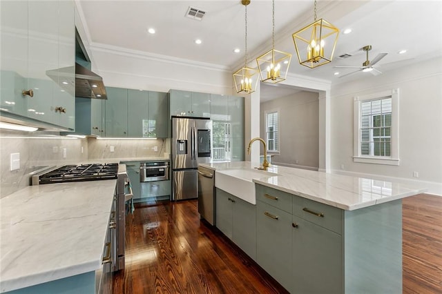 kitchen featuring an island with sink, dark wood-type flooring, sink, and stainless steel appliances