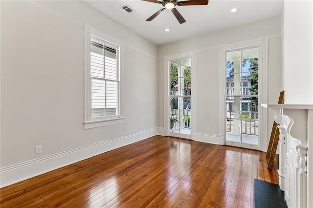 unfurnished room featuring hardwood / wood-style flooring and plenty of natural light