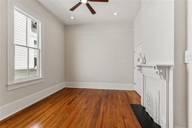 unfurnished living room featuring ceiling fan and hardwood / wood-style floors