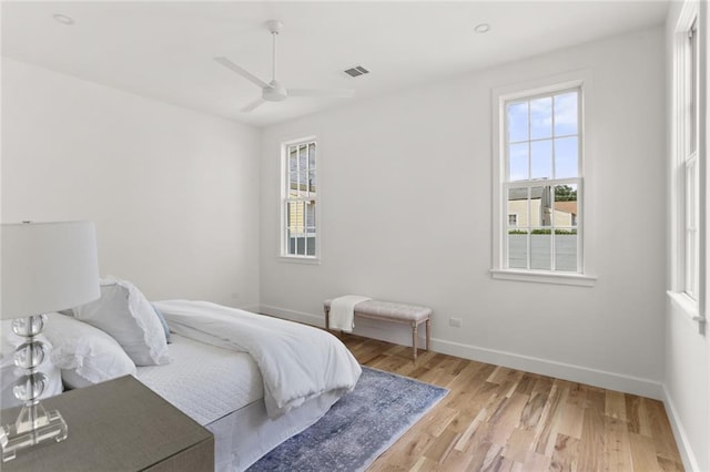 bedroom with light hardwood / wood-style floors and ceiling fan