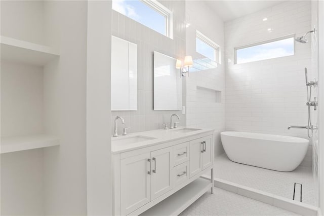 bathroom featuring tile walls, vanity, plus walk in shower, and tile patterned floors