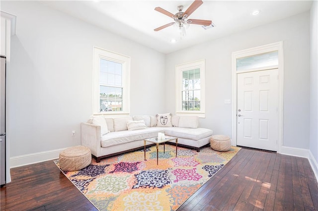 living room with ceiling fan, dark hardwood / wood-style floors, and a wealth of natural light