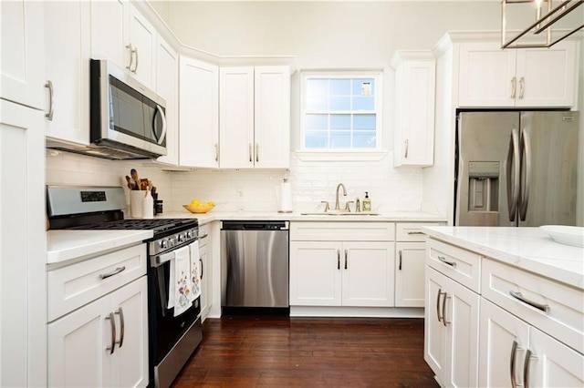 kitchen featuring white cabinetry, dark hardwood / wood-style flooring, sink, and stainless steel appliances