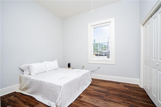 bedroom featuring a closet and dark hardwood / wood-style flooring