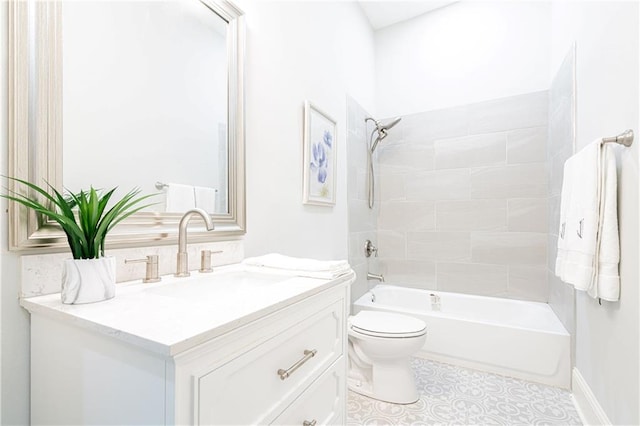 full bathroom featuring vanity, tiled shower / bath, and toilet