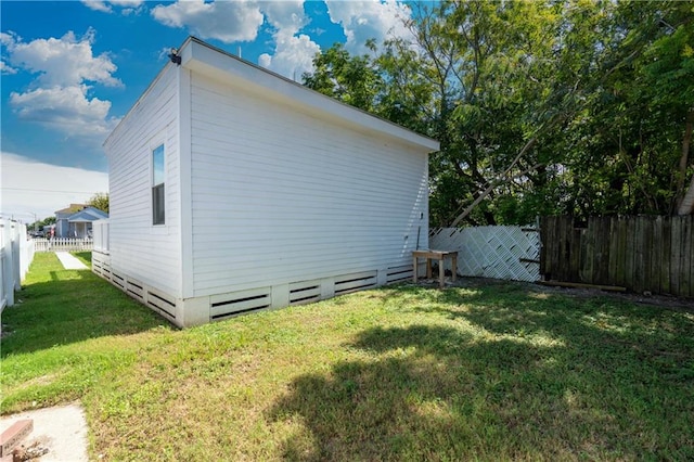 view of side of home with a lawn