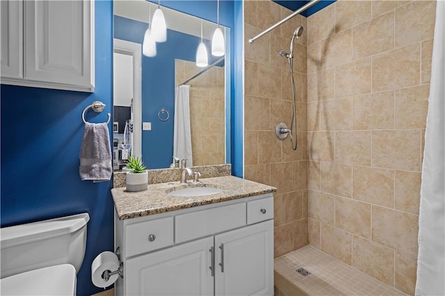 bathroom featuring toilet, curtained shower, and vanity