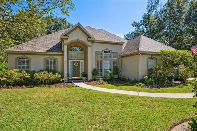 10 Catalpa Trce, Covington, LA 70433 - view of front facade with stucco siding, a front lawn, and a shingled roof
